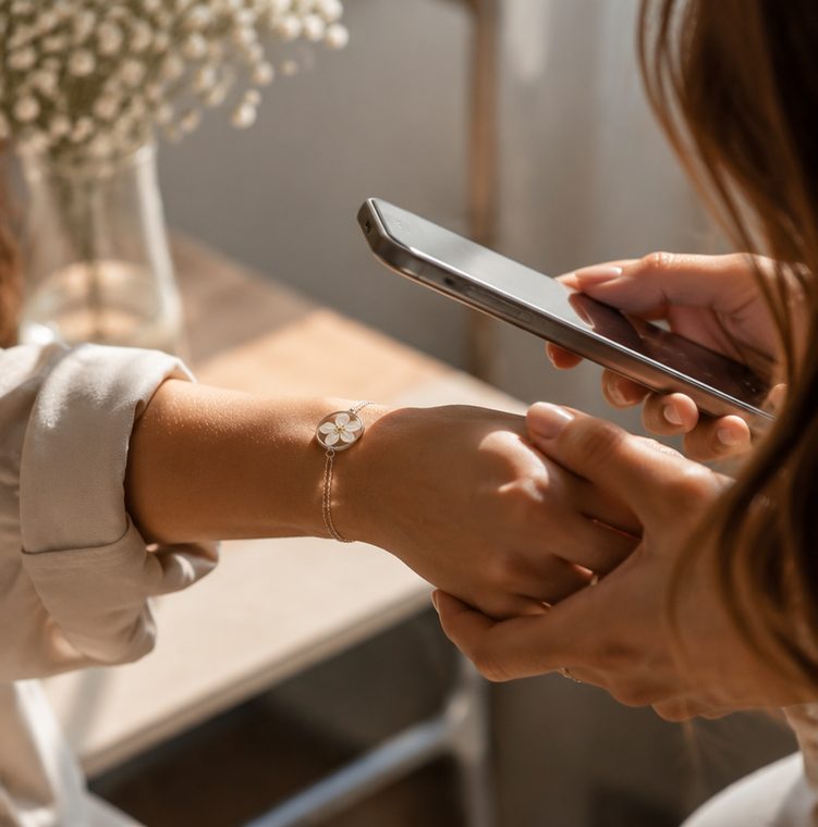 A Blesslet bracelet being scanned with a phone